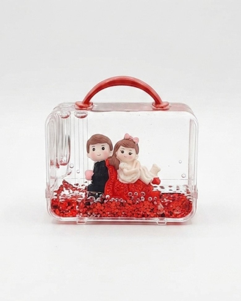 suitcase-shaped snow globe